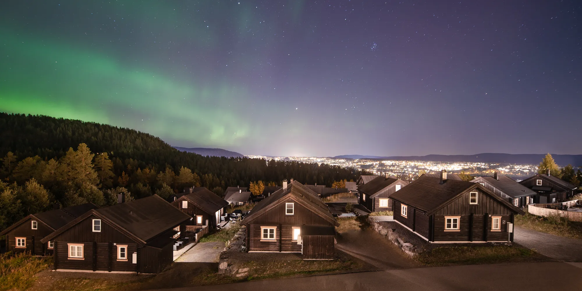 Northern lights over Norwegian cabins